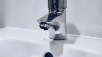 File photograph of a dripping household tap; not Desalcott or an affected Trinidad household.
